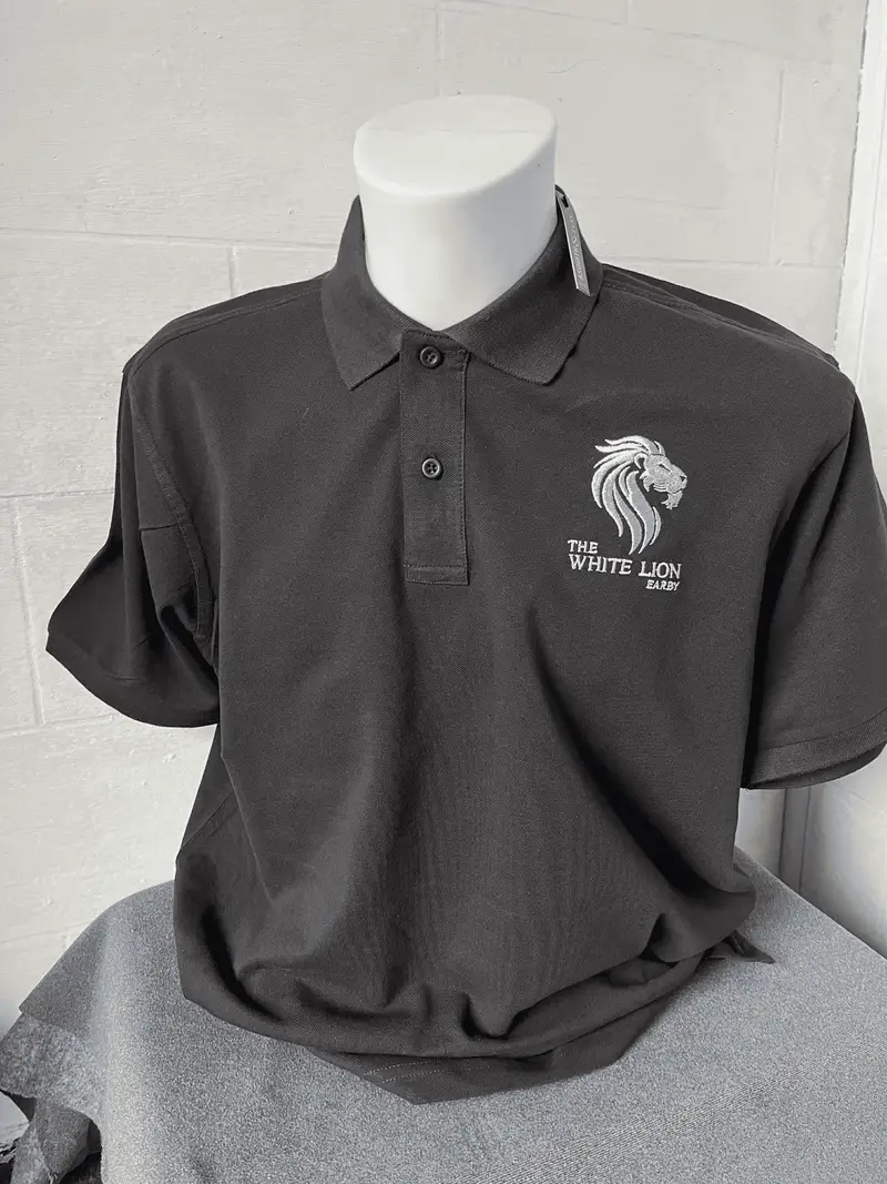 Grey polo shirt embroidered with The White Lion pub's lion head crest